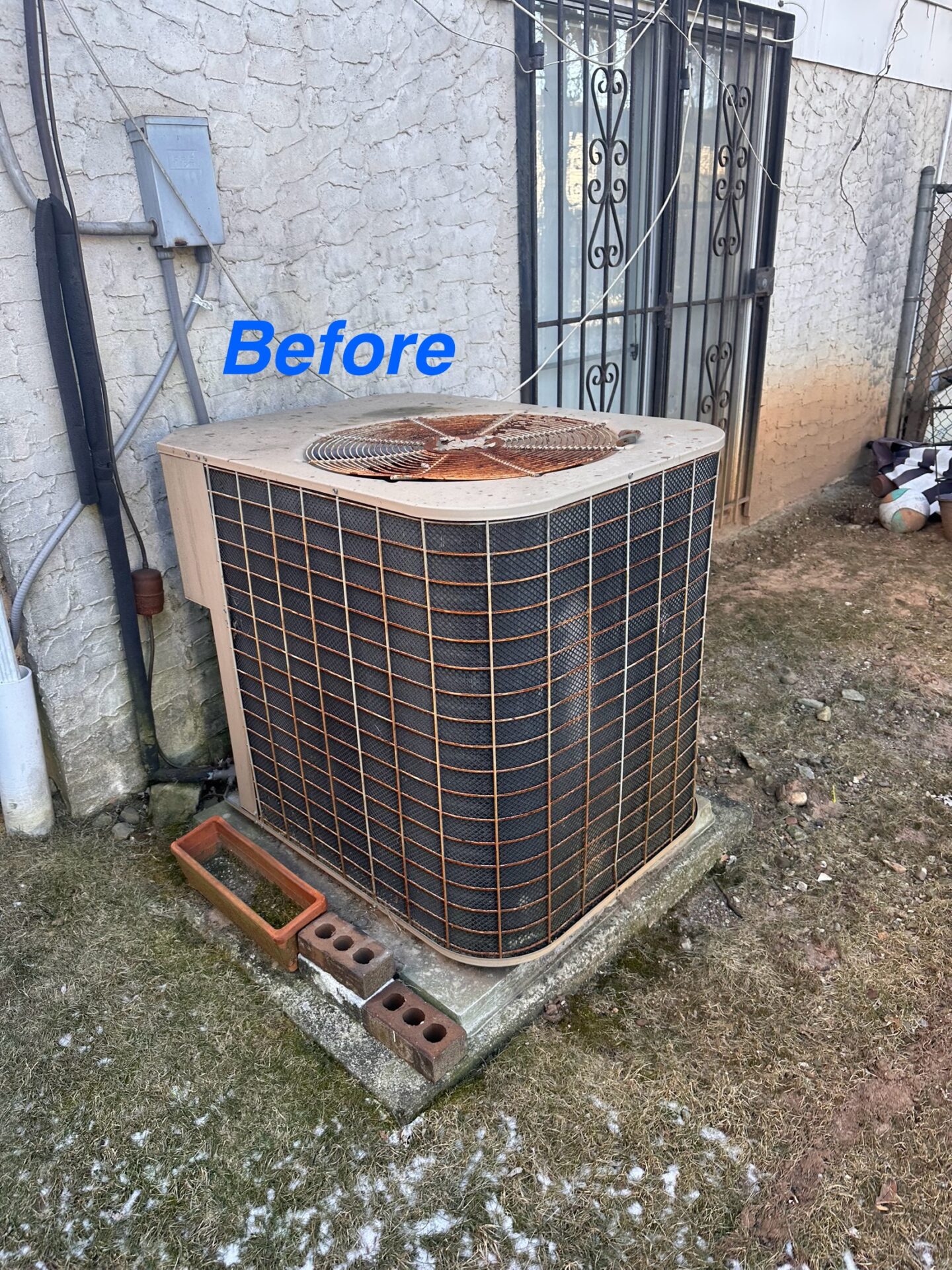 Old outdoor air conditioning condenser before replacement