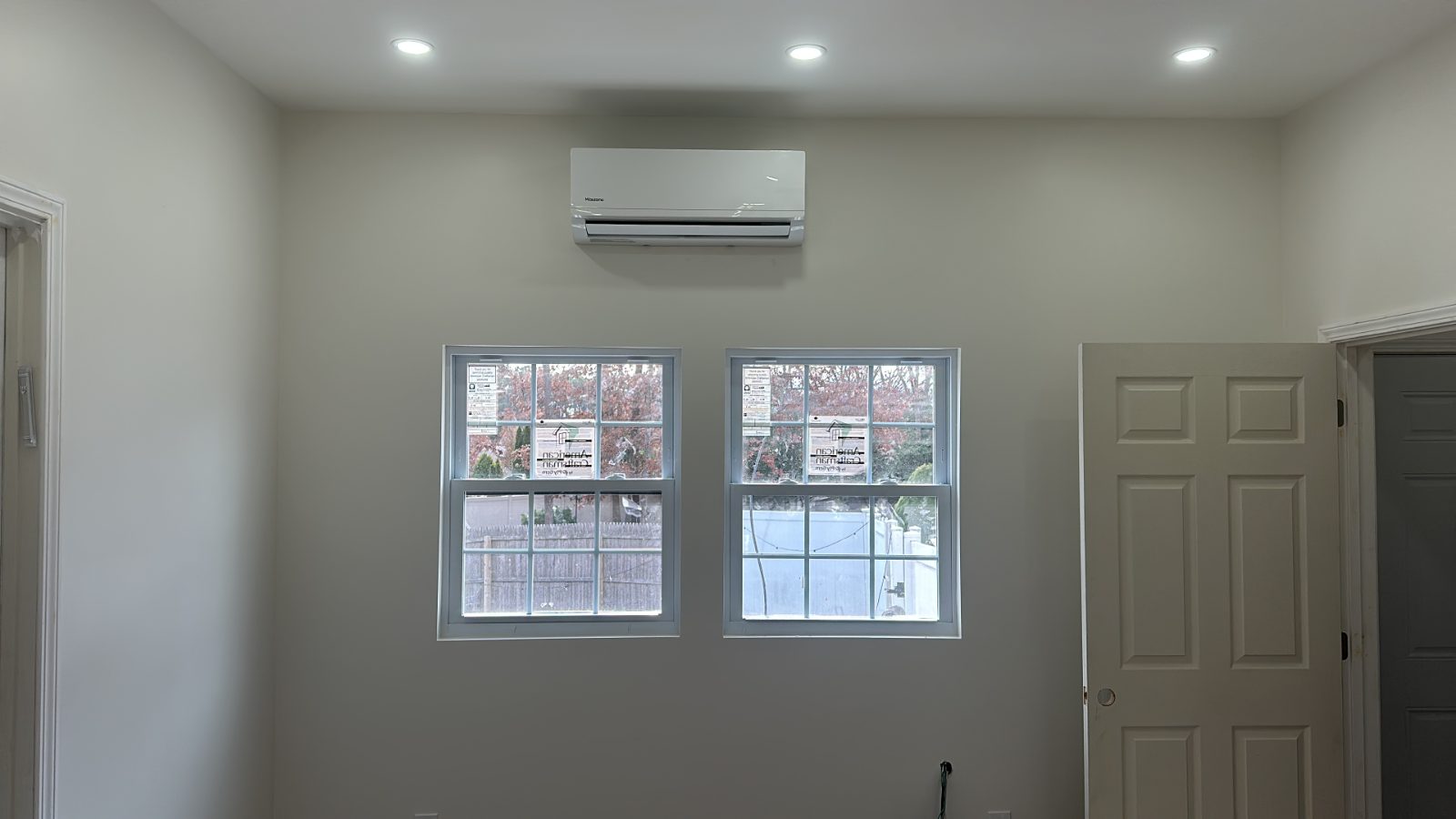 Ductless mini split indoor unit mounted above a window