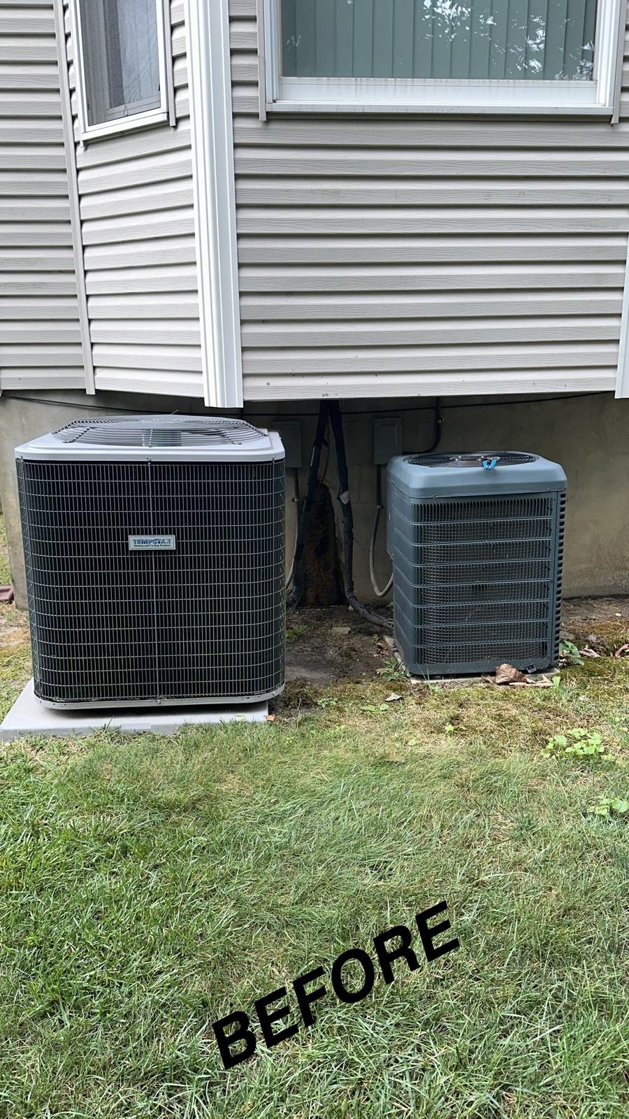 Two outdoor air conditioning condensers on a New Jersey lawn